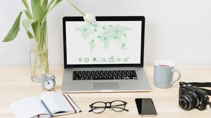 A laptop showing a map of business locations on a desk
