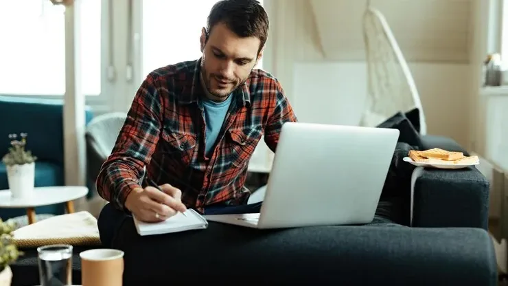 A small business owner working on SEO from a laptop at home
