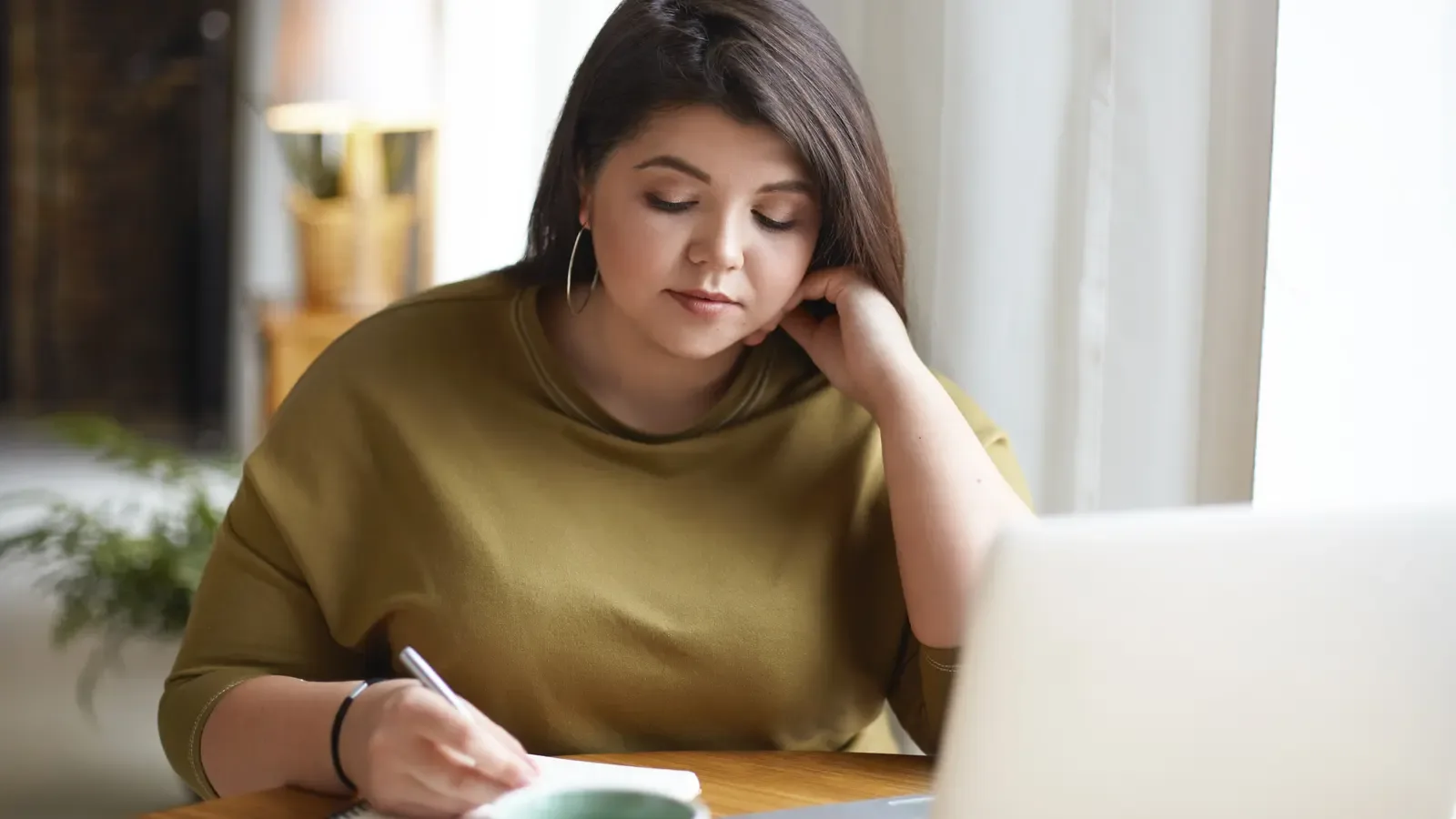 A business owner planning a timeline in a notebook