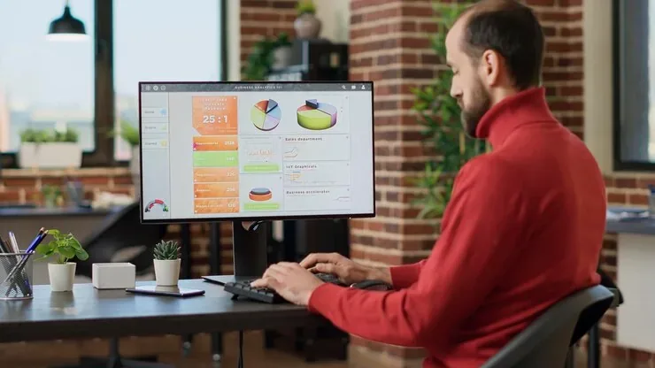 A business owner reviewing SEO reports and charts on a desktop screen