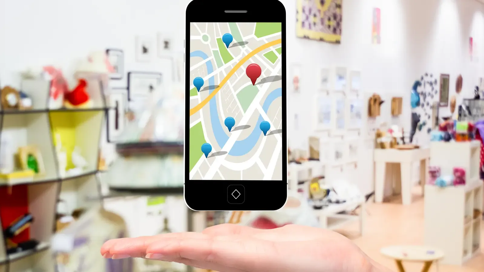 A phone showing local business pins on Google Maps inside a shop